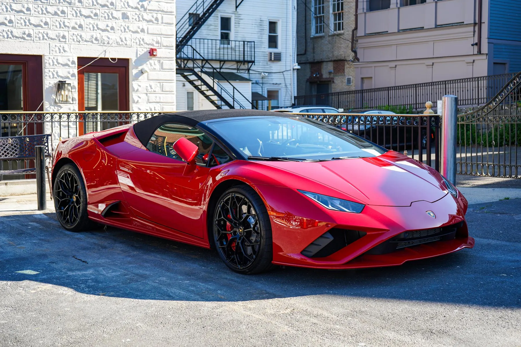 A red Lamborghini Huracán parked on a street after detailing.